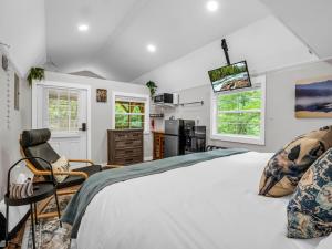 a bedroom with a large bed and a tv at Romantic King-Bed Couples Cabin Lake Lure in Lake Lure