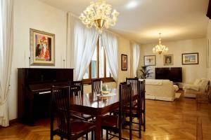 a living room with a dining table and a piano at Nama Boutique Residence in Venice