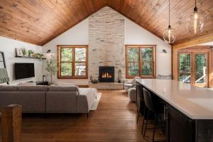 a living room with a couch and a fireplace at Chalet La Canopée -familial par excellence MontBlanc in Mont-Blanc
