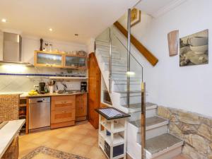 a kitchen with a spiral staircase in a house at Holiday Home Corazón de Vinaròs by Interhome in Vinaròs