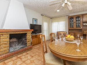 a living room with a table and a fireplace at Holiday Home Villa Pepin by Interhome in Vinaròs