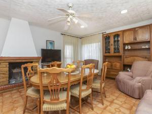 a dining room with a table and chairs and a fireplace at Holiday Home Villa Pepin by Interhome in Vinaròs
