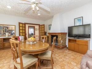 a dining room with a table and a fireplace at Holiday Home Villa Pepin by Interhome in Vinaròs