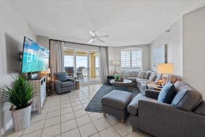 a living room with a couch and a tv at Beach Colony W7C - Covered Parking Included in Pensacola