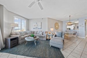 a living room with a couch and a table at Beach Colony W7C - Covered Parking Included in Pensacola