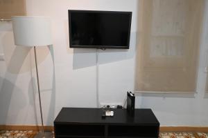 a living room with a black table and a flat screen tv at Homenfun Barcelona Sants Estación in Barcelona