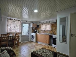 a kitchen with a table and a stove top oven at my Summerhouse in Kremasti