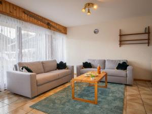 a living room with two couches and a coffee table at Apartment Austral 105 by Interhome in Ovronnaz