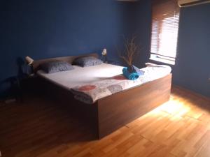 a large bed in a room with a window at FunHouse in Bucharest