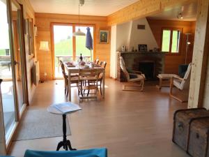 a dining room with a table and chairs and a fireplace at Chalet Sozi by Interhome in Le Châtelard-Montreux