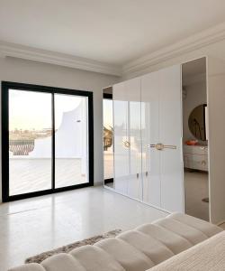 a living room with a large glass door at Villa Les Étoiles, Djerba in El Guecheïne +32 photos