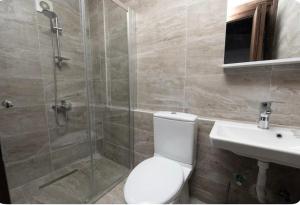 a bathroom with a shower and a toilet and a sink at Caterina Cornaro House in Famagusta