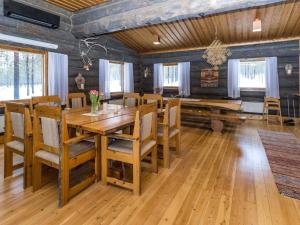 a dining room with a wooden table and chairs at Holiday Home Villa kopararova by Interhome in Saariselka +22 photos