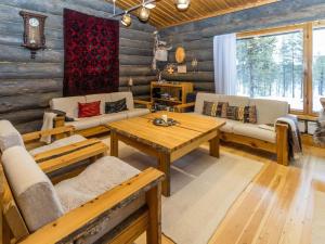 a living room with wooden walls and a table and chairs at Holiday Home Villa kopararova by Interhome in Saariselka