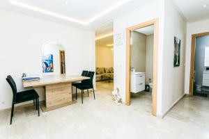 a room with a wooden table and chairs and a desk at Migdal Jaouhara in Marrakech +51 photos