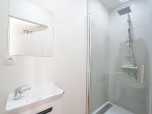 a bathroom with a shower and a sink and a mirror at Apartment Malecot II by Interhome in Blankenberge