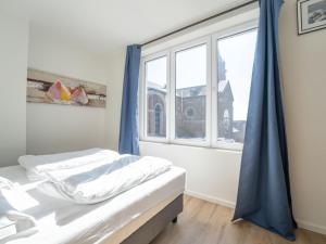 a bedroom with a bed and a large window at Apartment Malecot II by Interhome in Blankenberge