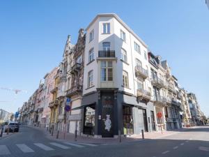 a tall white building on a city street at Apartment Malecot II by Interhome in Blankenberge