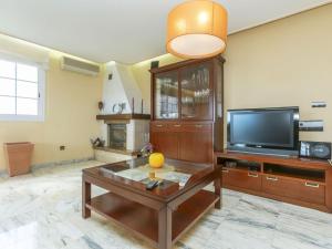 a living room with a television and a coffee table at Holiday Home Bon repos by Interhome in Cunit