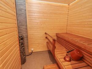 a small wooden sauna with a hat sitting in it at Holiday Home Huvila tornionjoen rannalla by Interhome in Pello