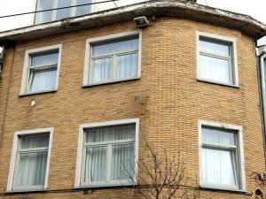 a brick building with six windows on it at DokAttic50 in Ghent
