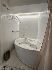 a white bathroom with a tub in a room at Apartment DB in Split +37 photos