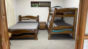 a room with two bunk beds in a room at Green Valley Glampling Salento - CASA CAMPESINA in Salento