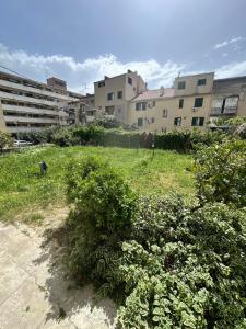 a field of grass with buildings in the background at Apartment DB in Split