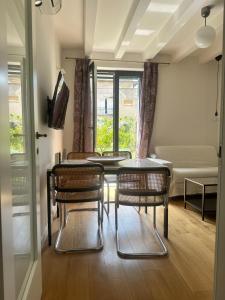 a dining room with a table and chairs and a couch at Apartment DB in Split