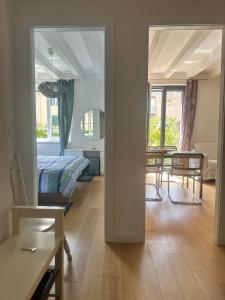 a bedroom and a living room with a bed and a table at Apartment DB in Split