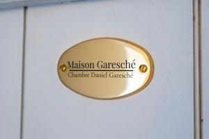 a gold door sign on a white door at Maison Garesché - Chambres d'hôtes de charme avec table d'hôtes in Nieulle-sur-Seudre +39 photos