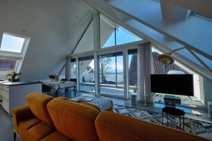 a living room with a couch and a large window at Ferienwohnung Munzert - Bodensee in Langenargen