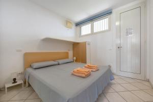 ein Schlafzimmer mit einem Bett mit zwei Handtüchern darauf in der Unterkunft Appartamento Lago Blu in Manerba del Garda