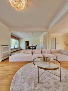 a living room with a couch and a table at Luxury Villa Pool & Spa in Halle +89 photos