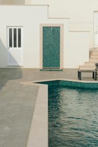 a pool in the middle of a building with a bench at Casa Isa Bela in Buarcos