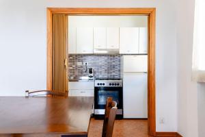 a kitchen with a table and a refrigerator at albatros seaview in Lido Adriano