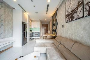 a living room with a couch and a kitchen at Saigon Landmark Cityview Apartment - PYG in Ho Chi Minh City