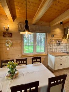 a dining room with a white table in a kitchen at U Marcjana in Kamienica Królewska