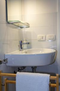 a bathroom with a white sink and a mirror at Cuore Flat in Modica +26 photos