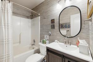 a bathroom with a sink and a toilet and a mirror at Herons Watch in Bumpass +25 photos