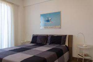 a bedroom with a bed and a picture on the wall at Cuore Flat in Modica