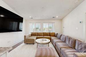 a living room with a large couch and a table at Oyster House Village --- 21503 Helm St in Rehoboth Beach