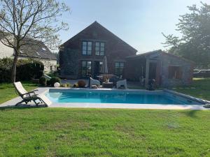a swimming pool in the yard of a house at Chez Eloi in Tacfesse