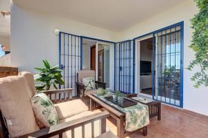 a living room with a couch and a table at 105 Welcoming Andalusian Style 2 Bed Apartment With Views of Miraflores Golf in Sitio de Calahonda