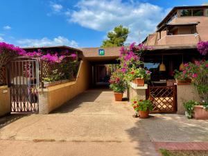 a house with flowers on the front of it at Casa Smeralda By Anthimea in Cugnana Verde