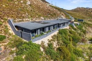 a house on the side of a hill at Red River Valley by Host Agents in Rooiels