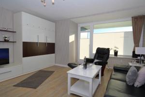 a living room with a couch and a table at Haus Käptn Christiansen 46 in Westerland