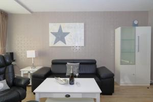 a living room with a couch and a table at Haus Käptn Christiansen 46 in Westerland