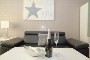 a table with a bottle of wine and a glass at Haus Käptn Christiansen 46 in Westerland
