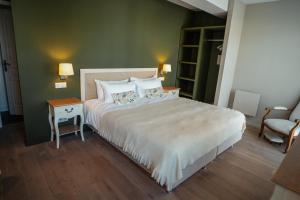 a bedroom with a large bed with two pillows at Maison d'hôtes PACHAMAMA in Ahetze